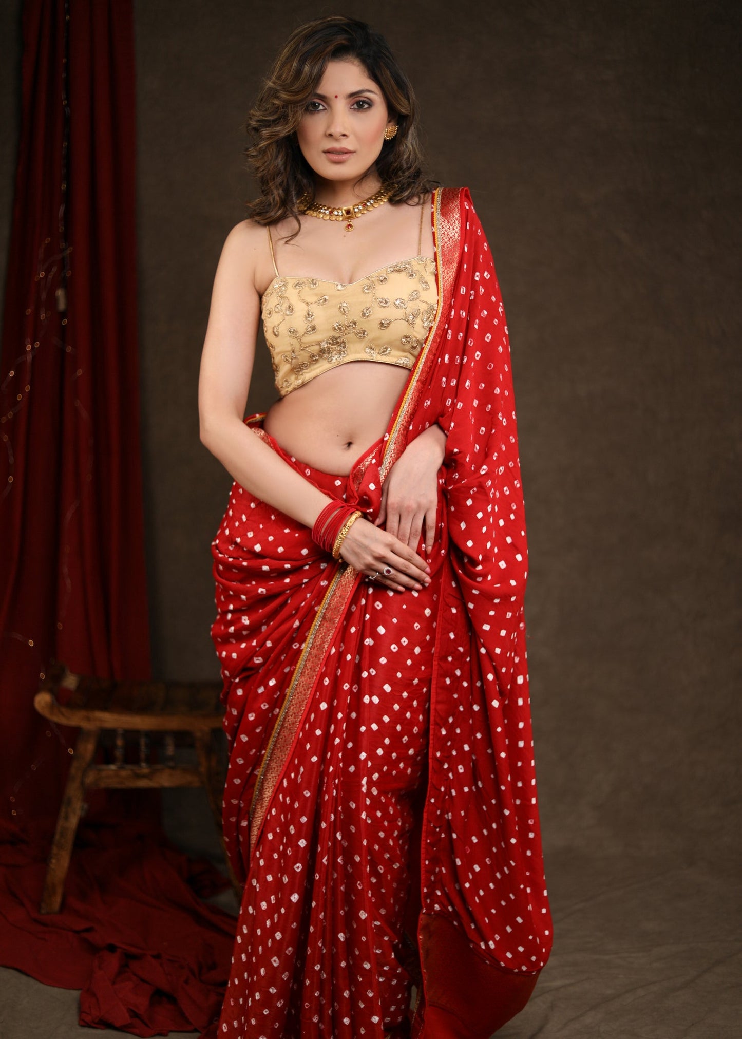 Radiant Red Bandhej Saree with Delicate Gold And Banarasi Detailing