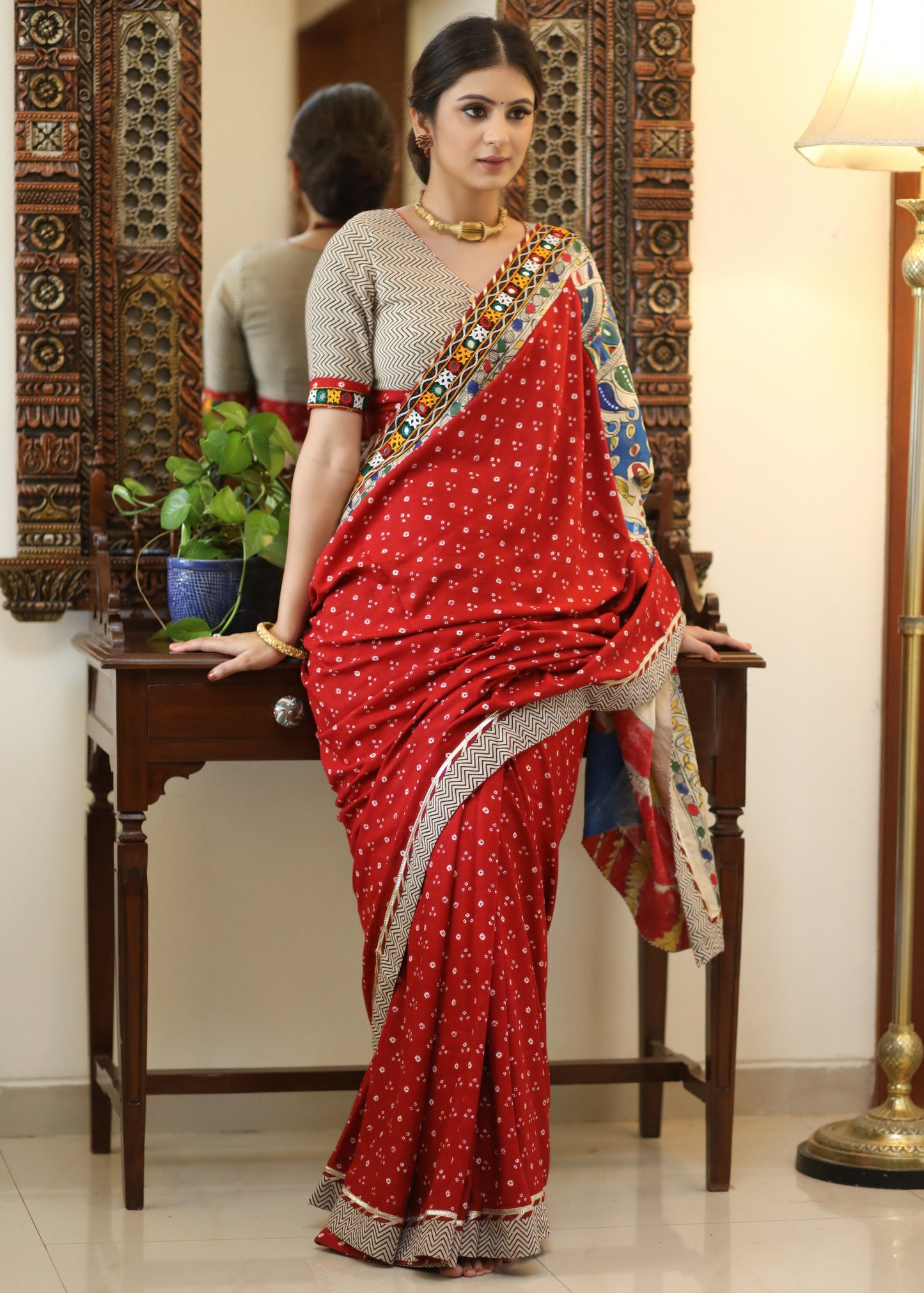 Exclusive red Bandhani saree with elegant hand painted Madhubani Pallu and mirror work border