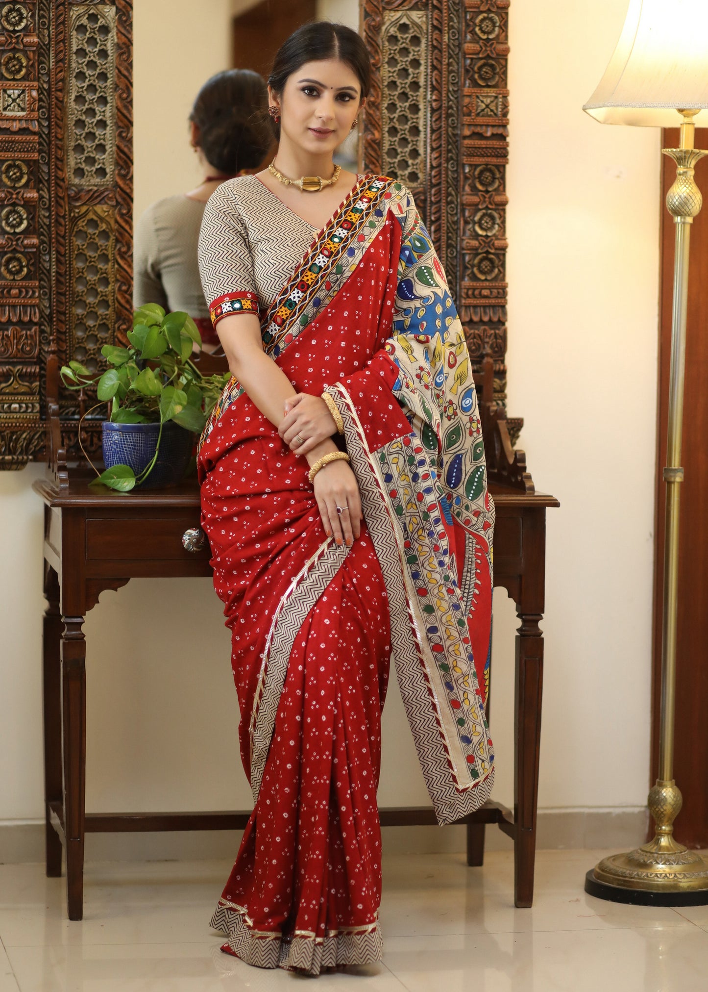 Exclusive red Bandhani saree with elegant hand painted Madhubani Pallu and mirror work border