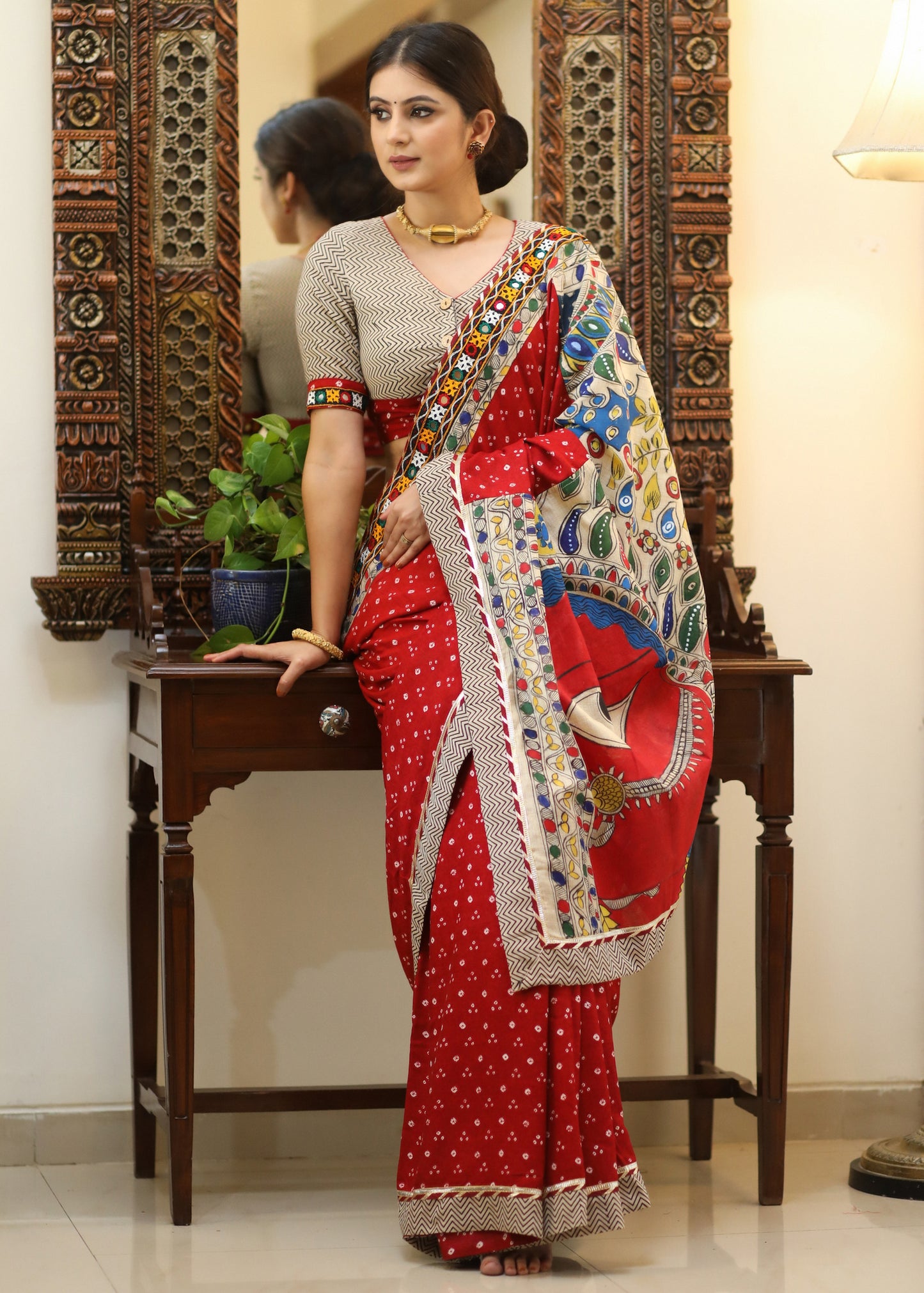 Exclusive red Bandhani saree with elegant hand painted Madhubani Pallu and mirror work border