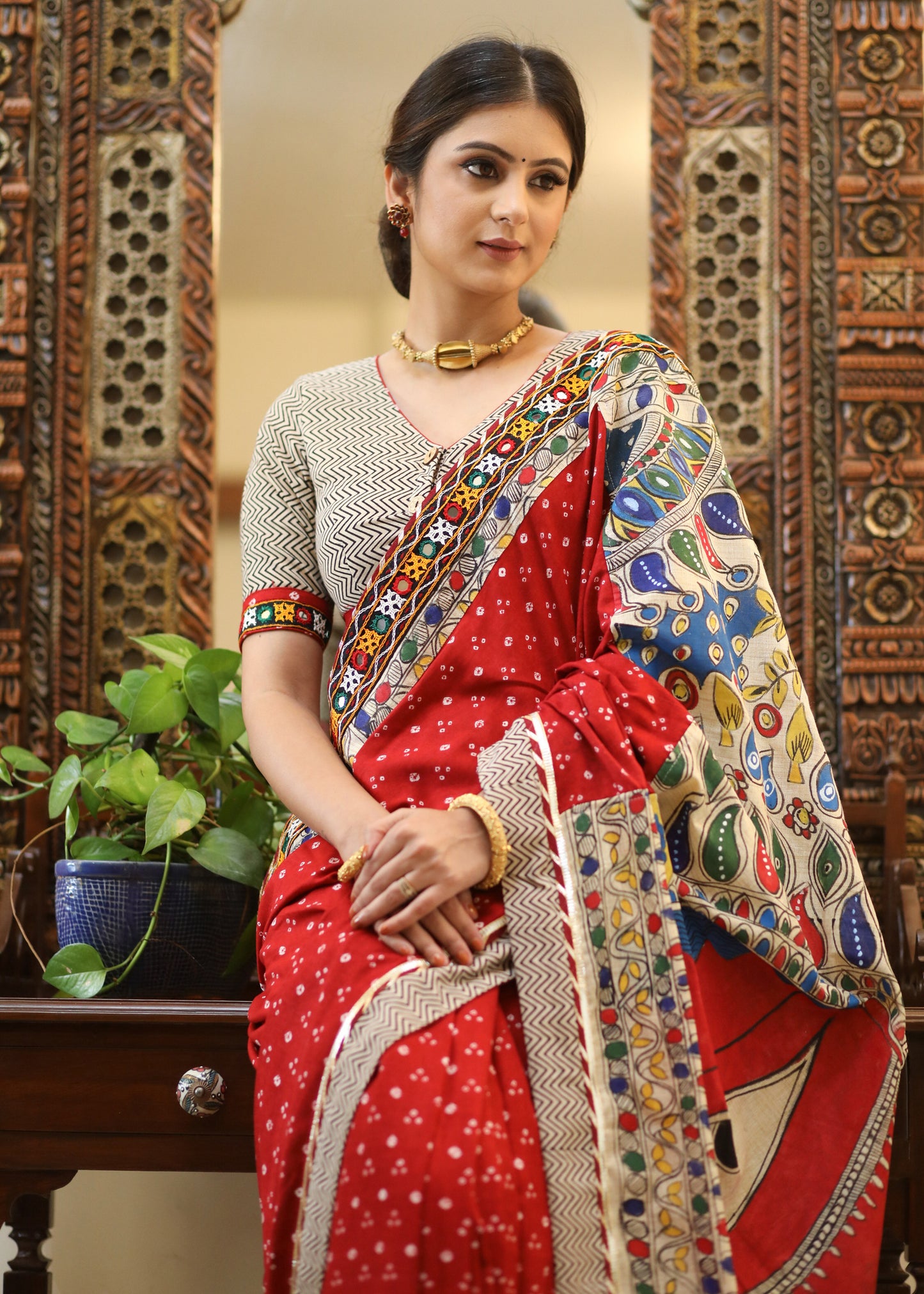 Exclusive red Bandhani saree with elegant hand painted Madhubani Pallu and mirror work border