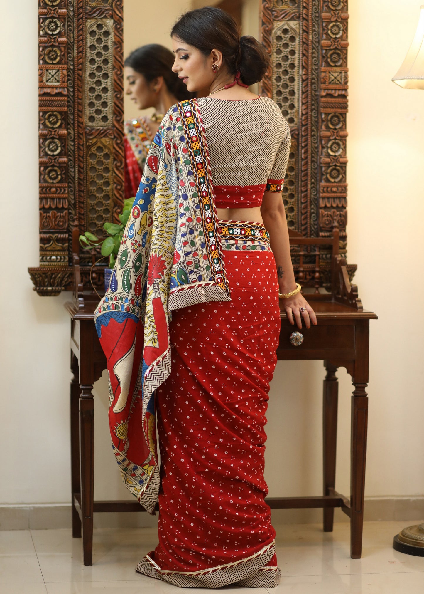 Exclusive red Bandhani saree with elegant hand painted Madhubani Pallu and mirror work border