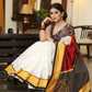 Smart white Chanderi saree with exclusive Kalamkari hand painted border and maroon Pallu with mirror work