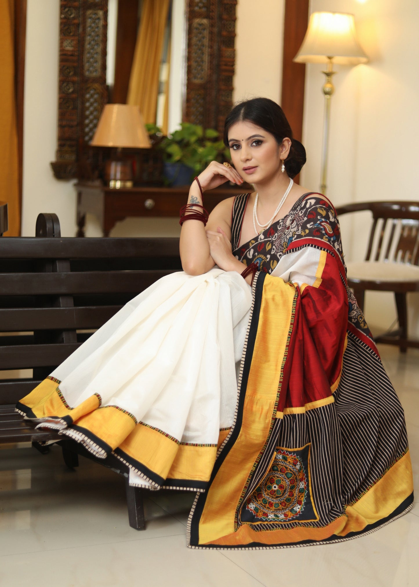 Smart white Chanderi saree with exclusive Kalamkari hand painted border and maroon Pallu with mirror work