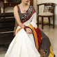 Smart white Chanderi saree with exclusive Kalamkari hand painted border and maroon Pallu with mirror work