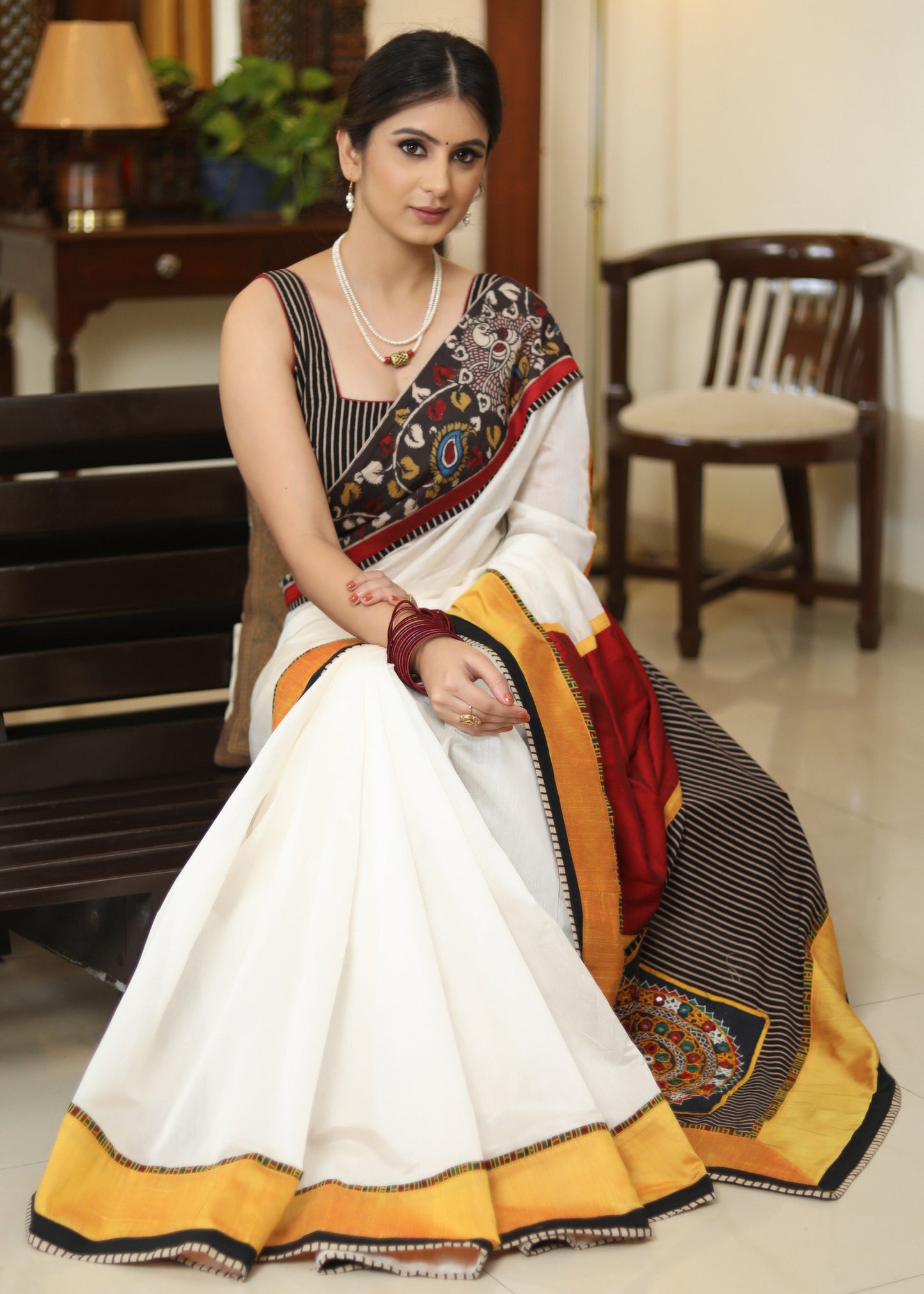 Smart white Chanderi saree with exclusive Kalamkari hand painted border and maroon Pallu with mirror work