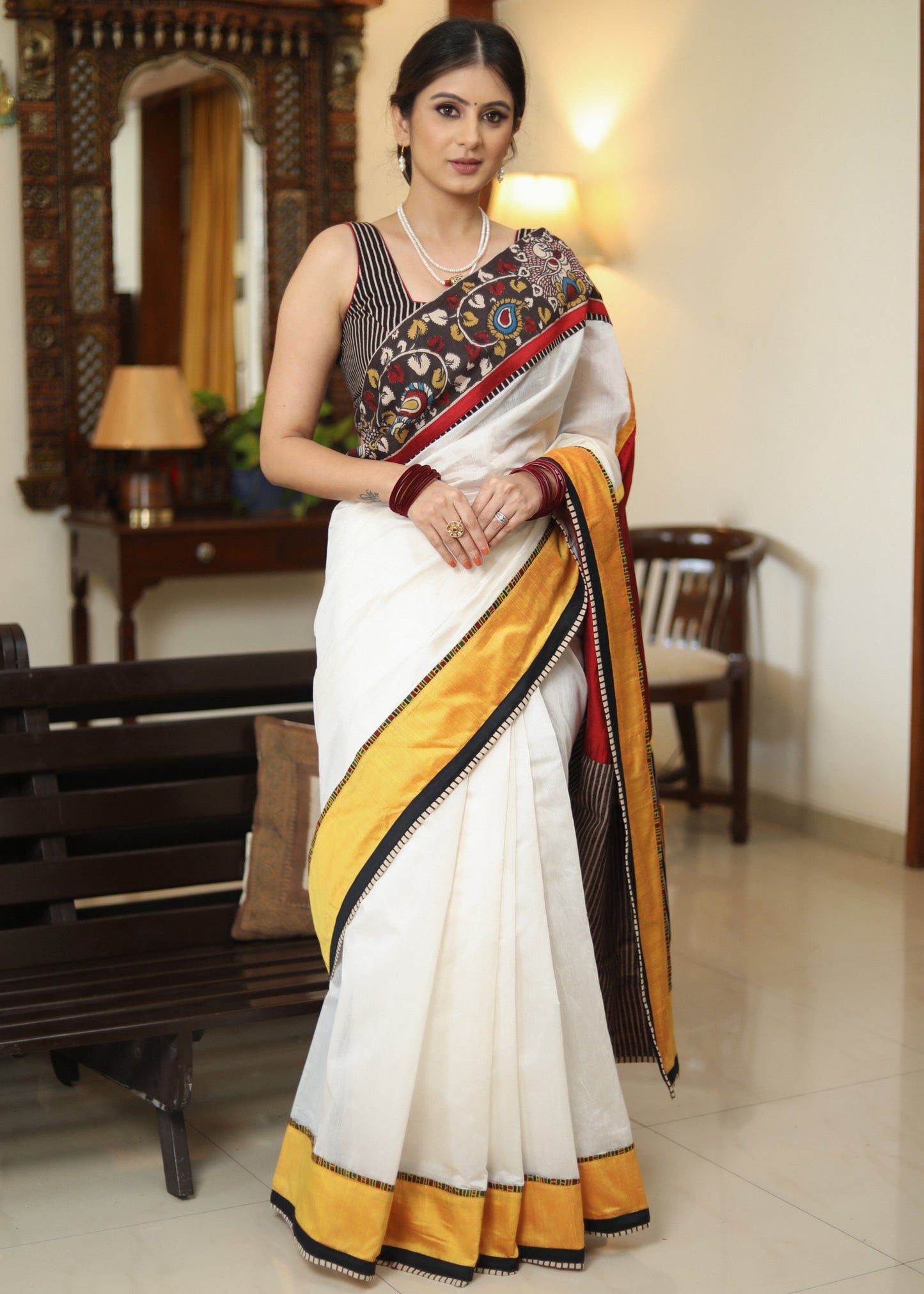 Smart white Chanderi saree with exclusive Kalamkari hand painted border and maroon Pallu with mirror work