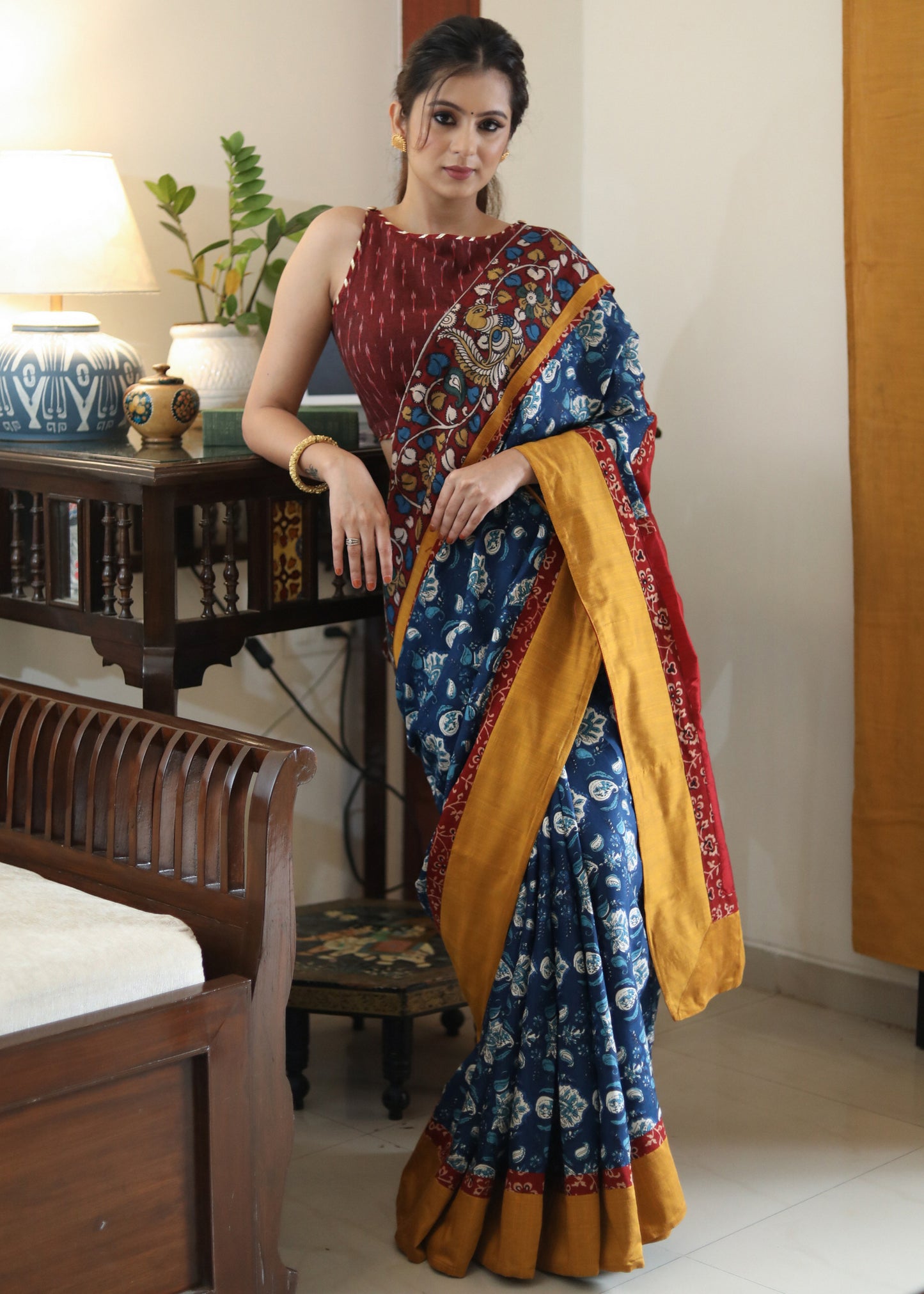 Lustrous blue printed saree graceful Madhubani painted Pallu with maroon and mustard border