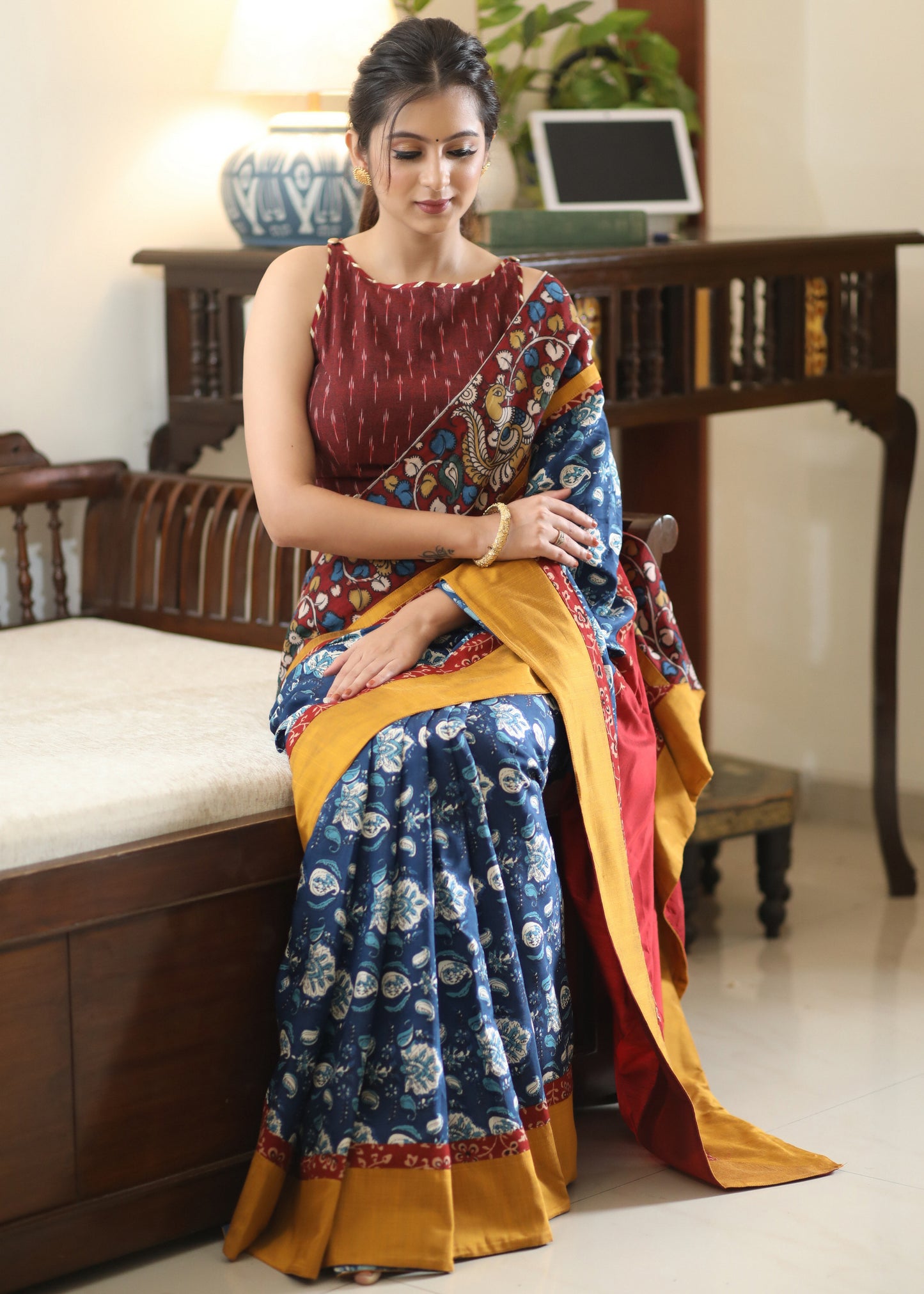 Lustrous blue printed saree graceful Madhubani painted Pallu with maroon and mustard border