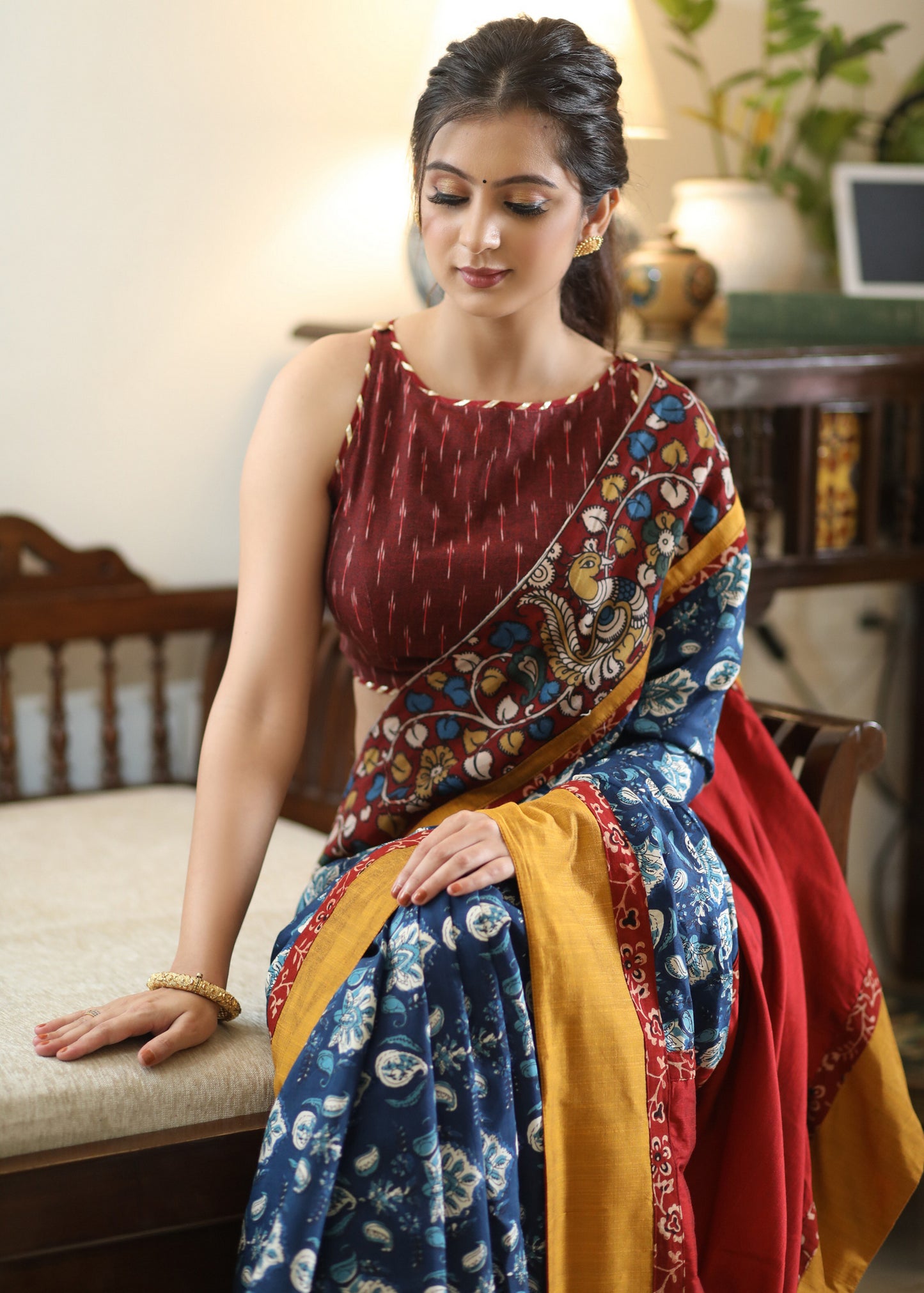 Lustrous blue printed saree graceful Madhubani painted Pallu with maroon and mustard border