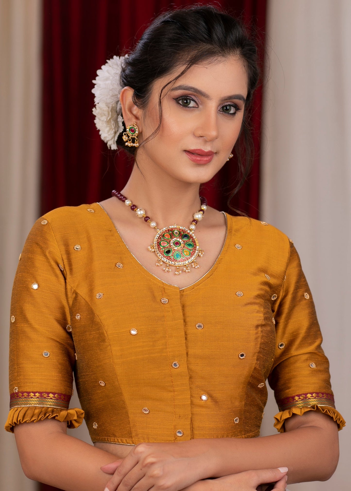 Exclusive metallic gold blouse with overall mirror embroidery highlighted with banarasi lace