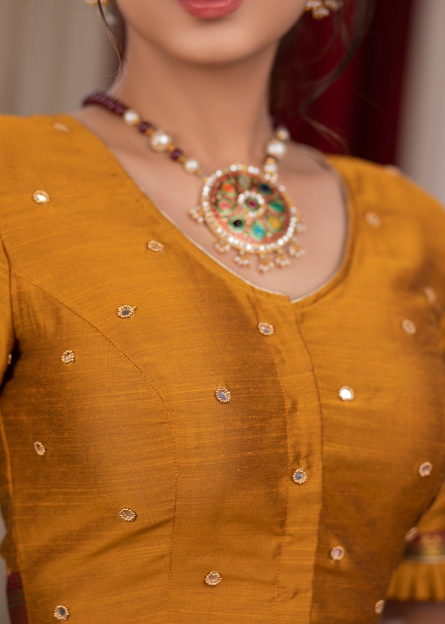 Exclusive metallic gold blouse with overall mirror embroidery highlighted with banarasi lace