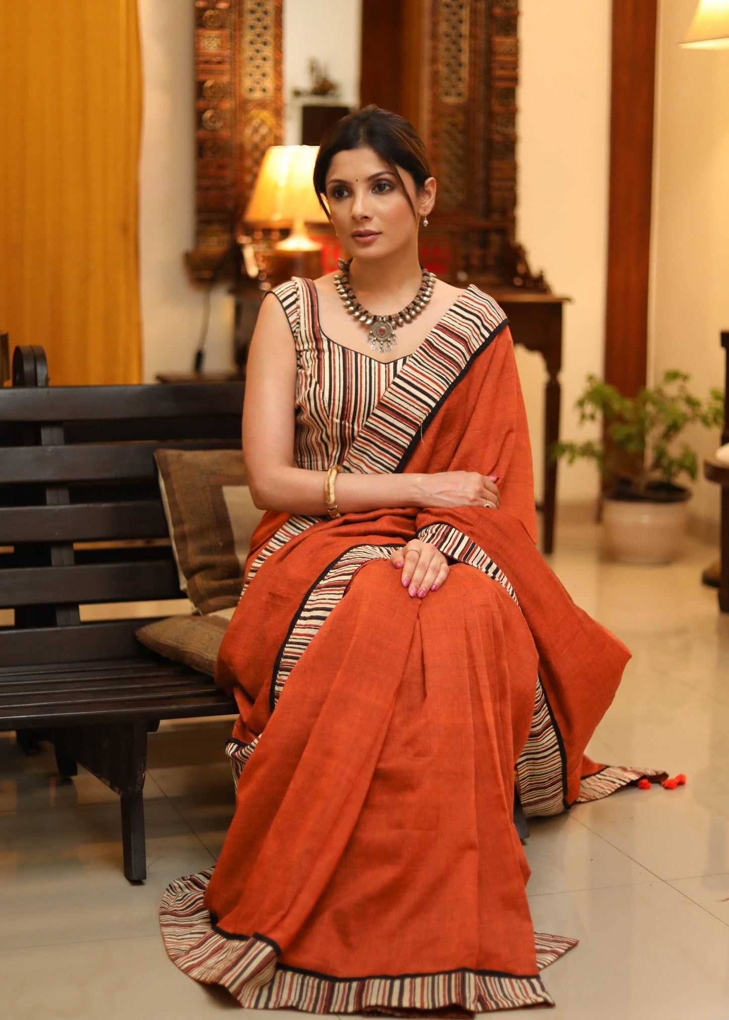 Exquisite rust Cotton plain saree with line Ajrakh border