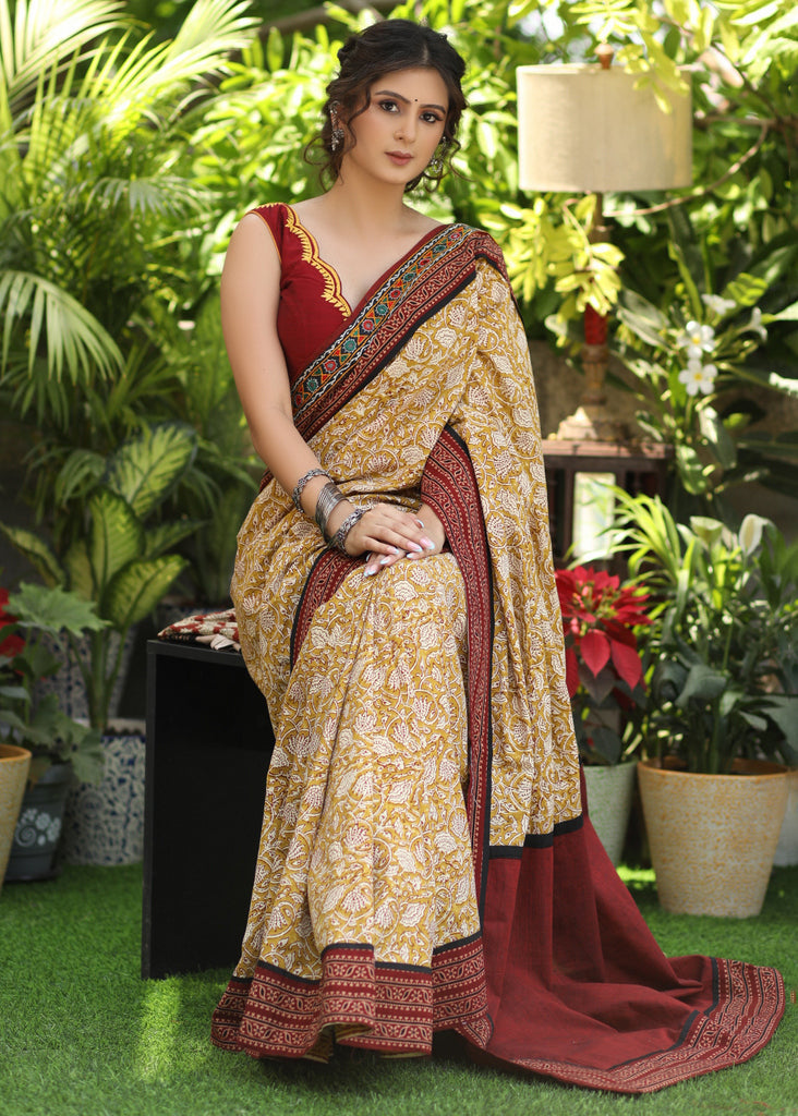 Exclusive mustard printed Cotton saree Accentuated with Ajrakh and Mirror border