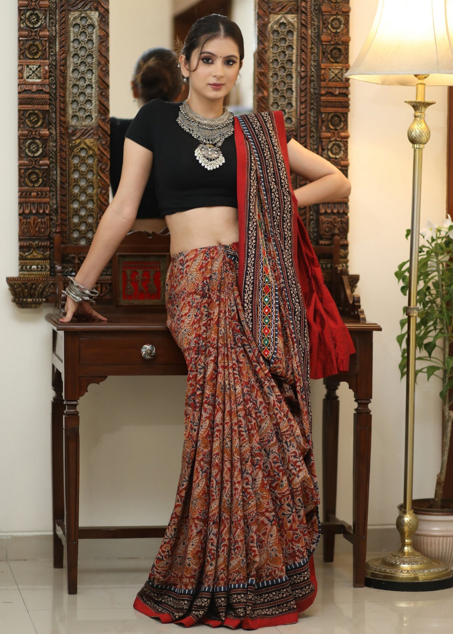 Stylish Cotton Kalamkari print saree with mirrorwork and Ajrakh border.