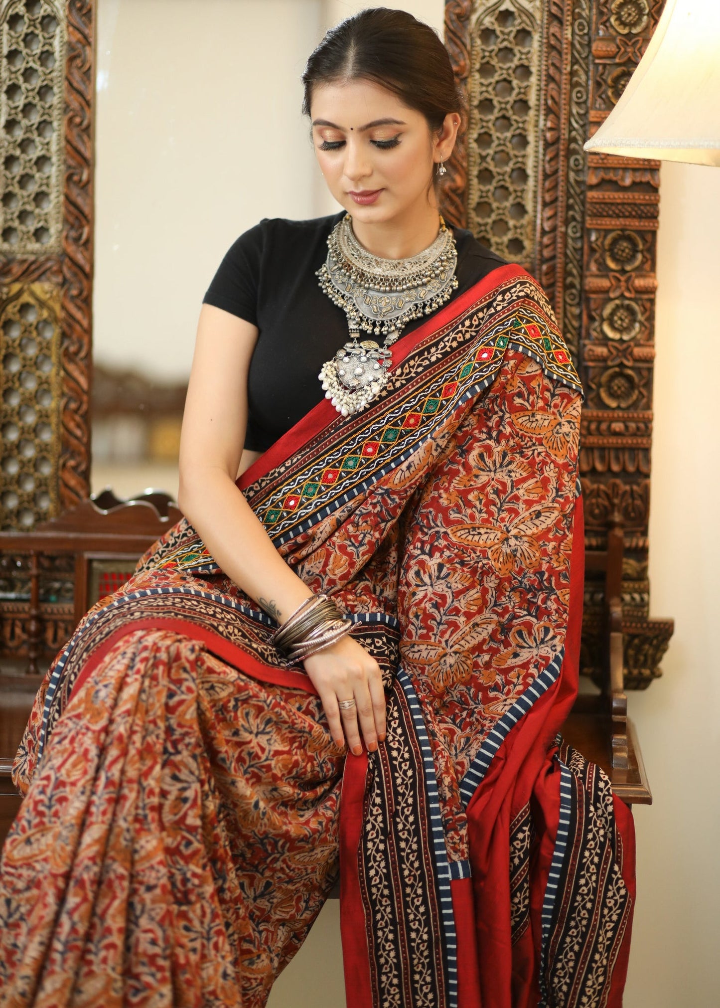 Stylish Cotton Kalamkari print saree with mirrorwork and Ajrakh border.