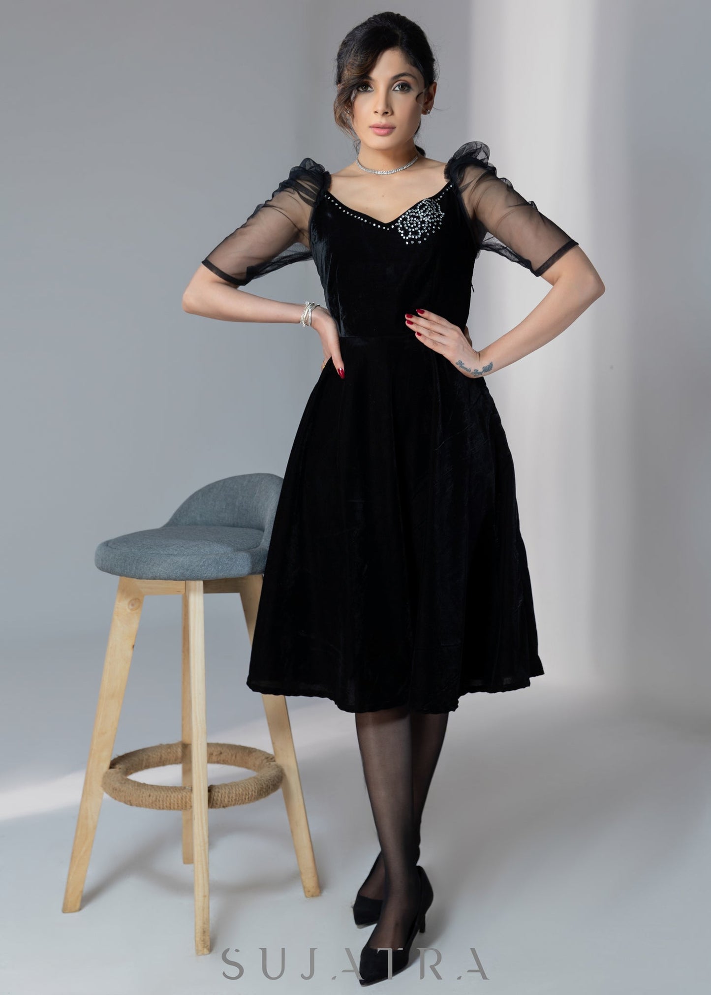 Exclusive black velvet dress with net sleeves & stone work on neckline