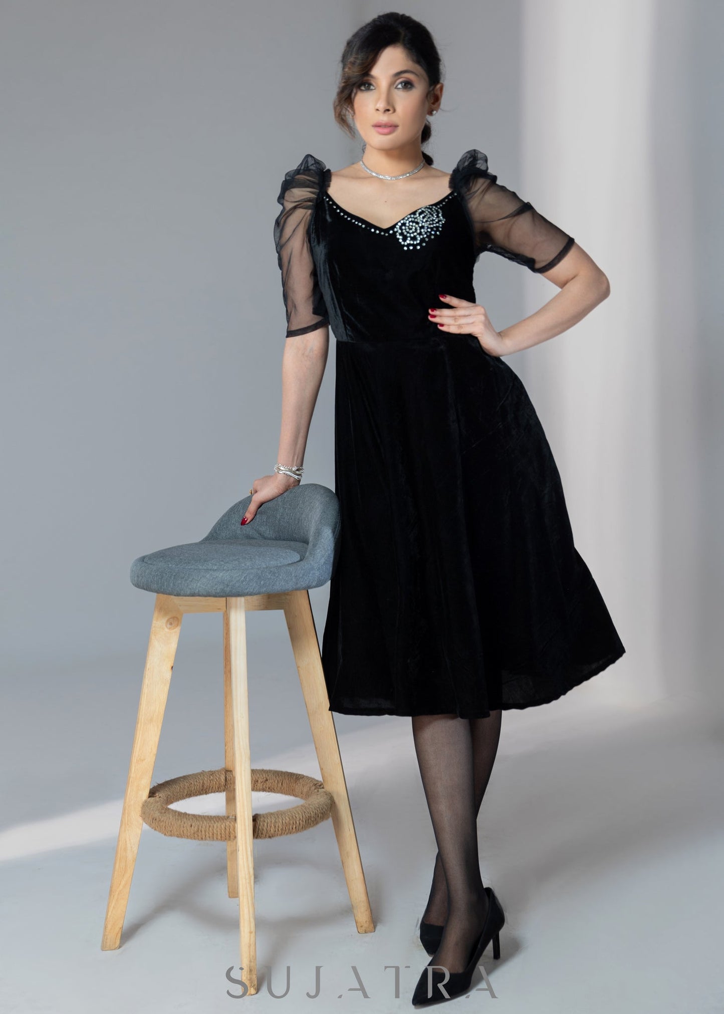 Exclusive black velvet dress with net sleeves & stone work on neckline