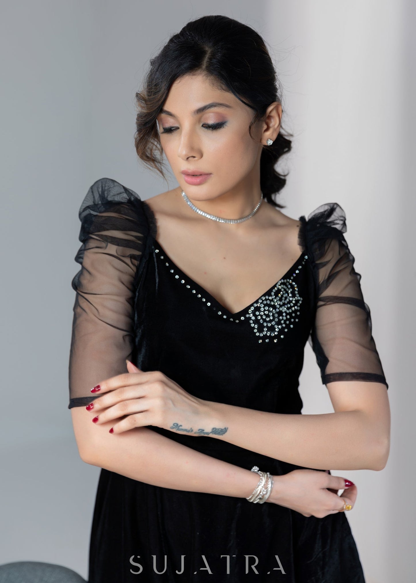 Exclusive black velvet dress with net sleeves & stone work on neckline