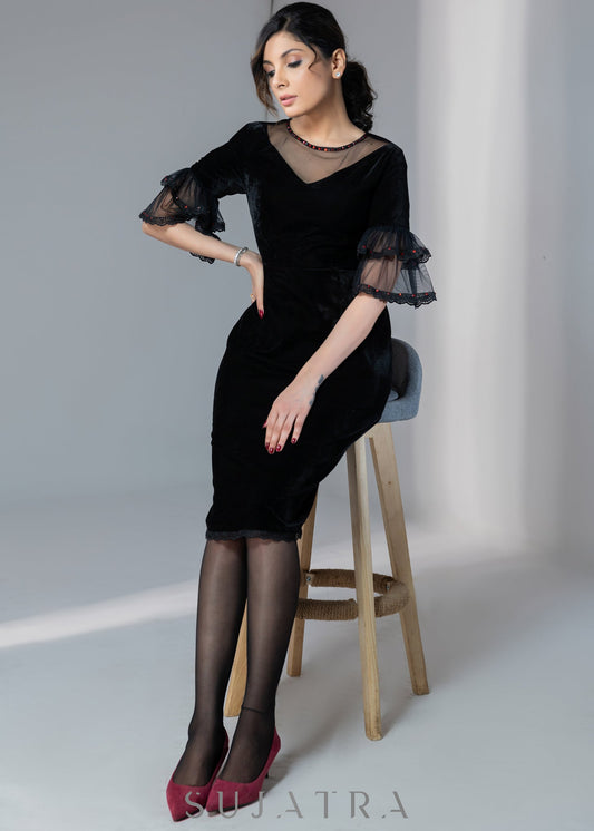 Party wear black velvet dress with net sleeves & red stone work detailing on the neck