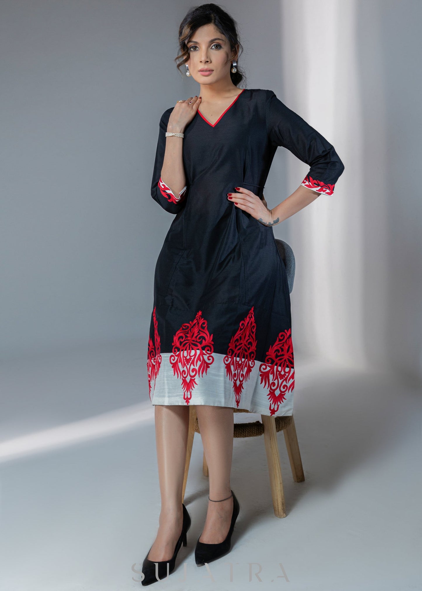 Black cotton silk dress with red embroidery motifs on hem