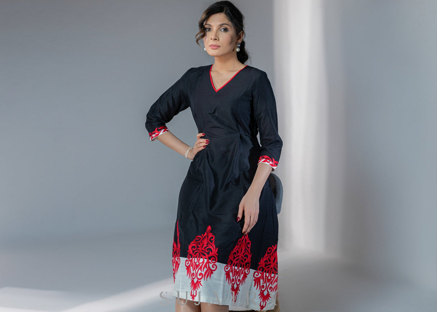 Black cotton silk dress with red embroidery motifs on hem