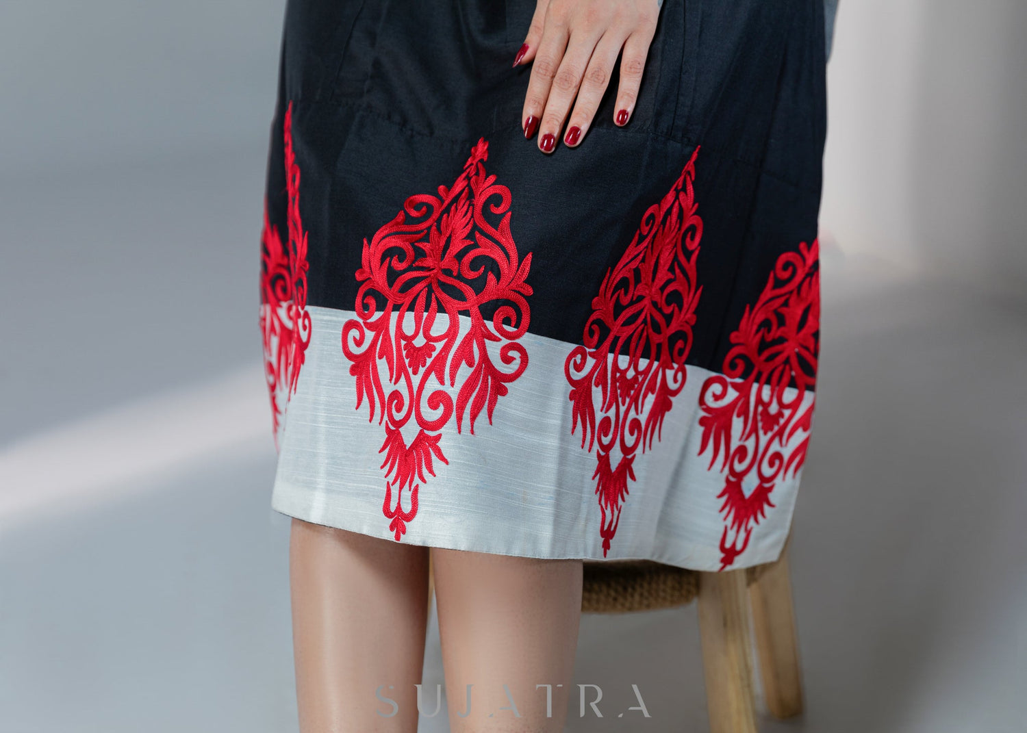 Black cotton silk dress with red embroidery motifs on hem