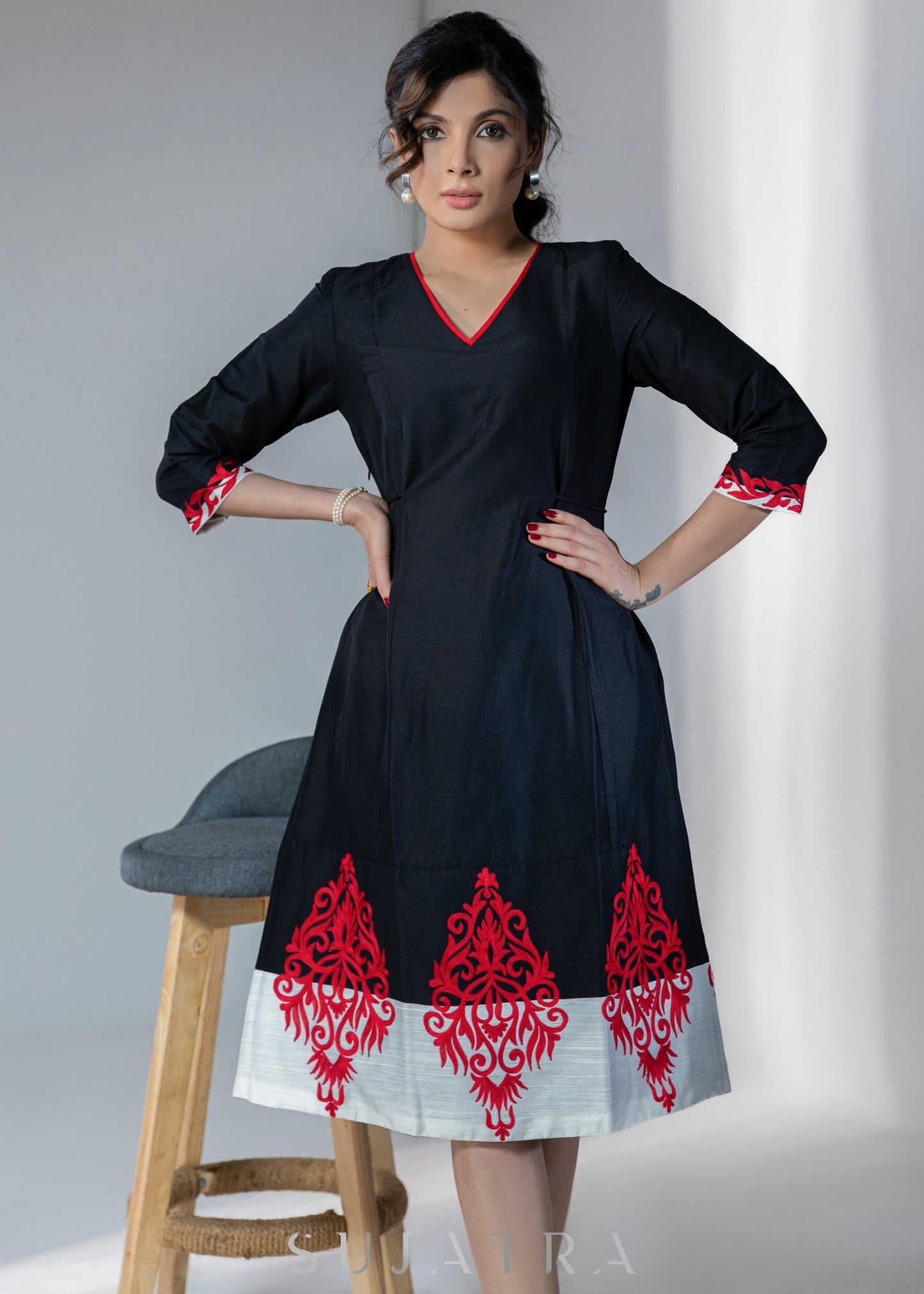 Black cotton silk dress with red embroidery motifs on hem