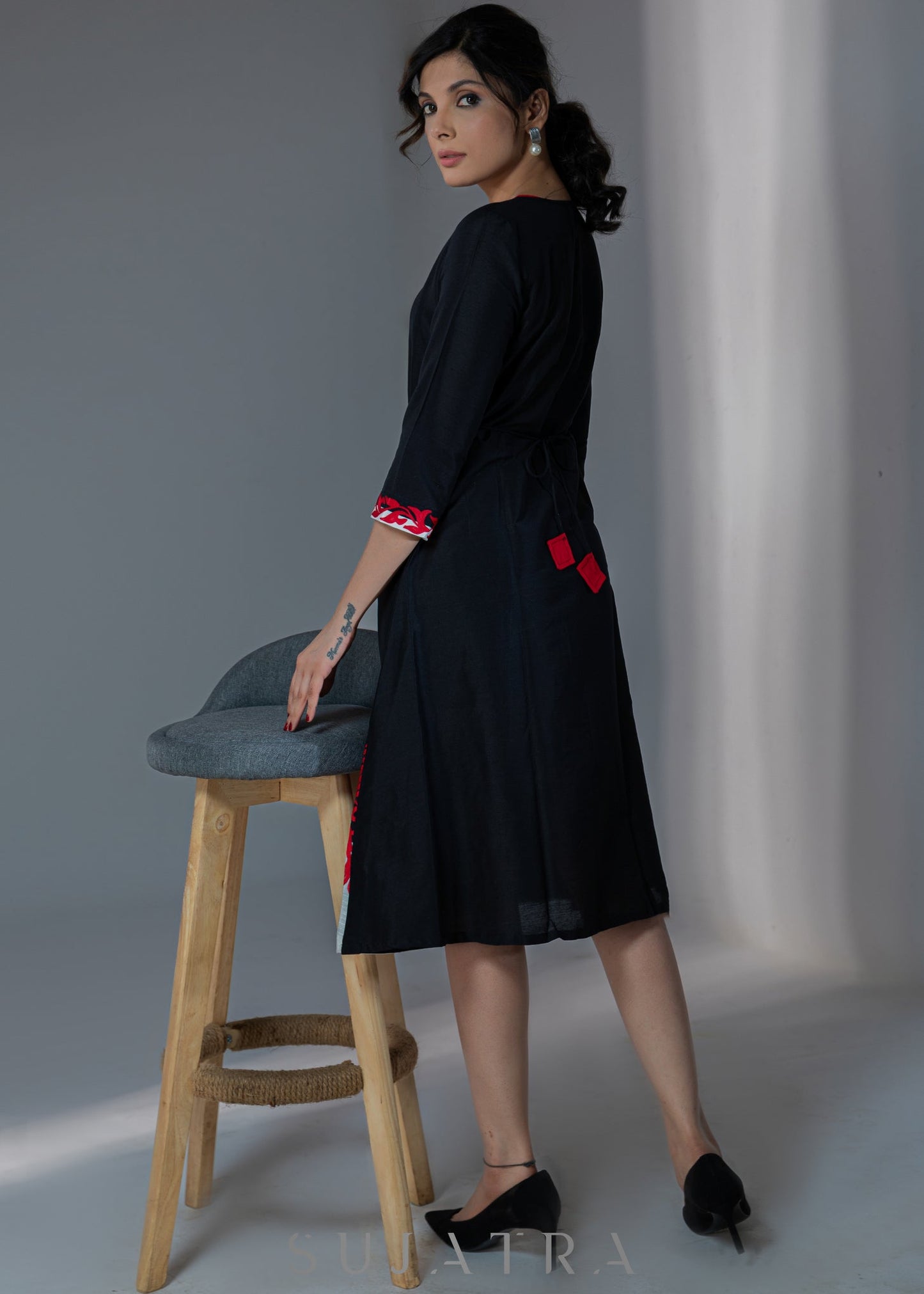 Black cotton silk dress with red embroidery motifs on hem